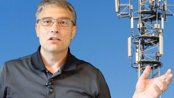 Person standing near wireless tower with Choosing Wireless text