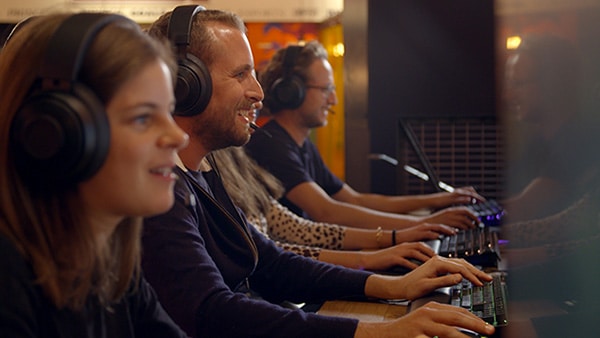 Gamers in front of computers, wearing headsets