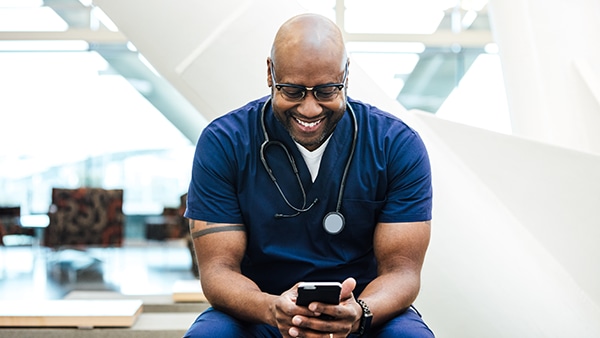 Healthcare worker looks at smartphone